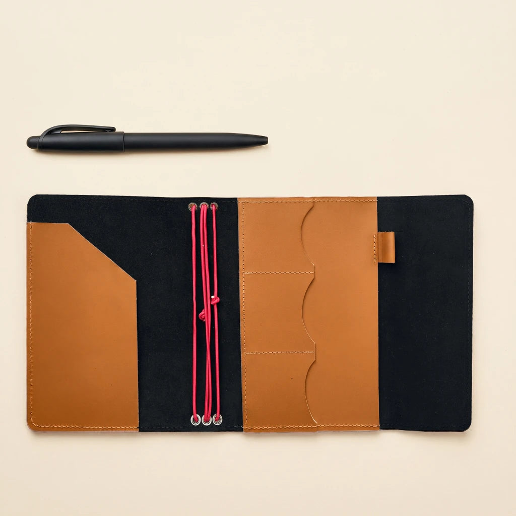 Soft leather notebook cover with elastic straps and classic travel journal style
