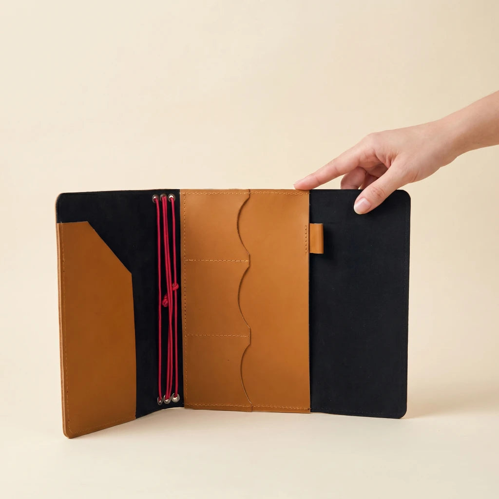 Leather notebook portfolio with elastic bands, inner pockets, and pen holder feature