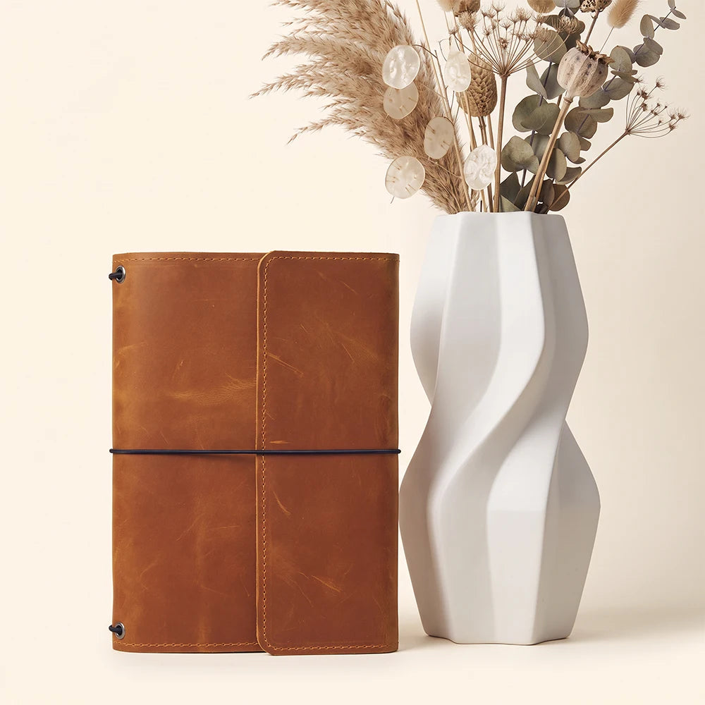 Refillable leather notebook portfolio with spacious interior layout and handcrafted leather craftsmanship.