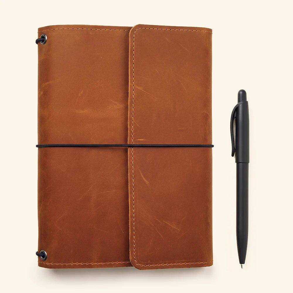 Genuine leather refillable notebook wrap with interior storage and durable handcrafted construction.