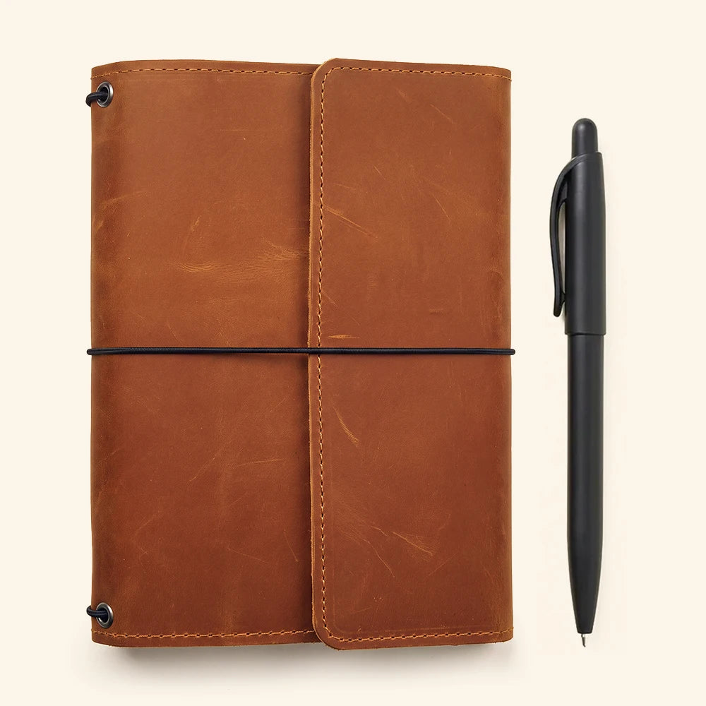 Genuine leather notebook sleeve with practical organization features and refillable insert capability.