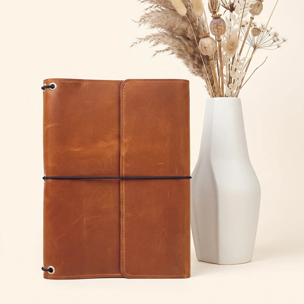 Vintage leather notebook portfolio designed with interior organization and refillable journal compatibility.