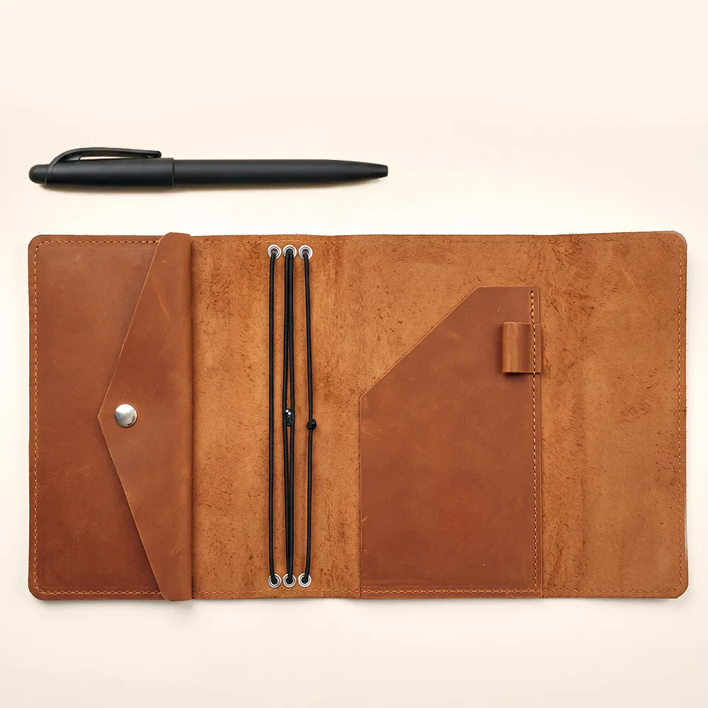 Leather journal cover with refillable inserts, three elastic bands, and practical interior compartments.