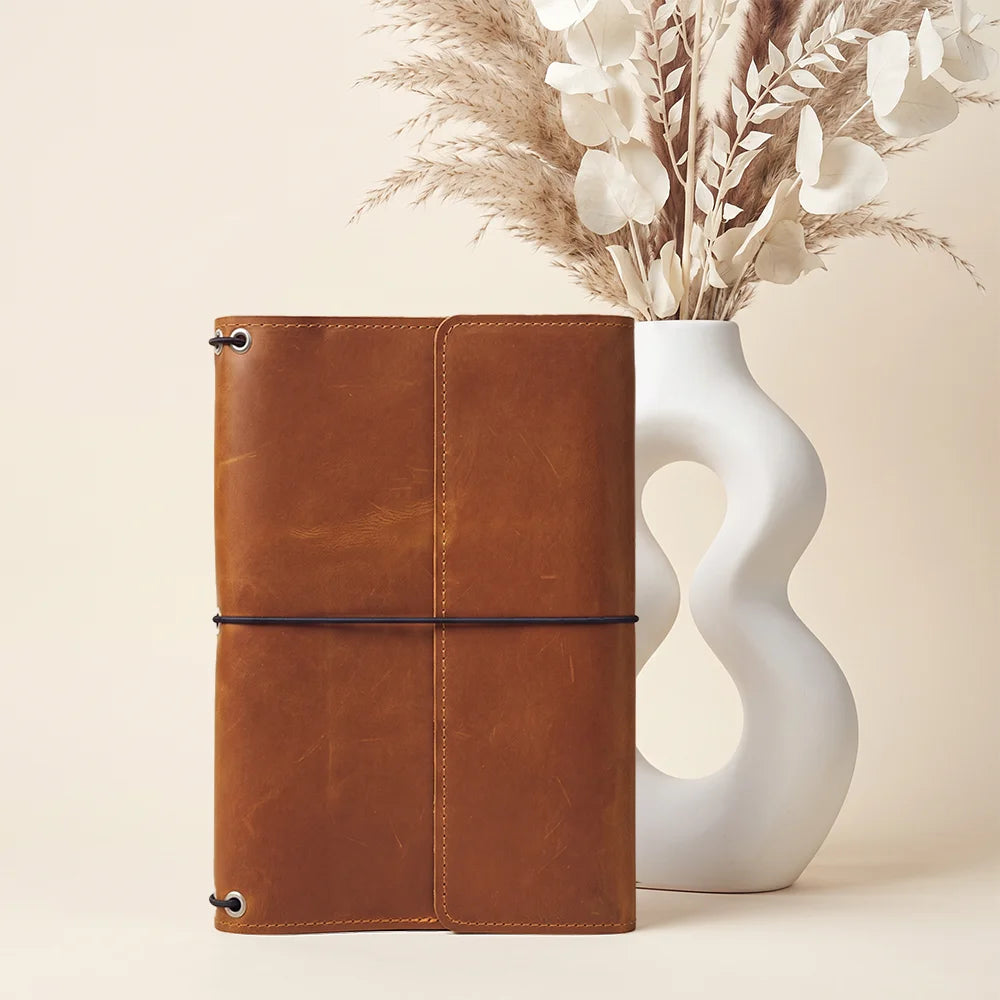 Refillable leather notebook cover with thoughtful interior organization for work, school, and travel.
