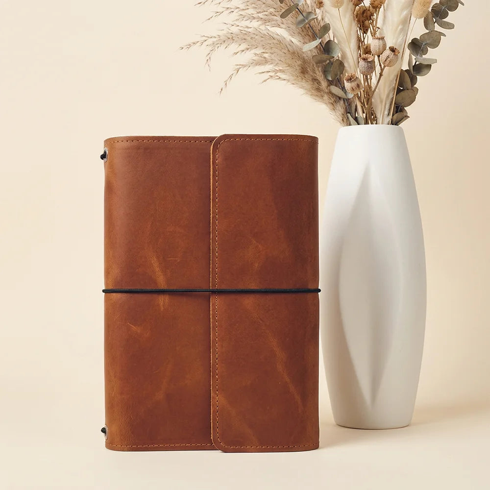 Handmade natural leather journal cover with functional pockets and a secure pen loop