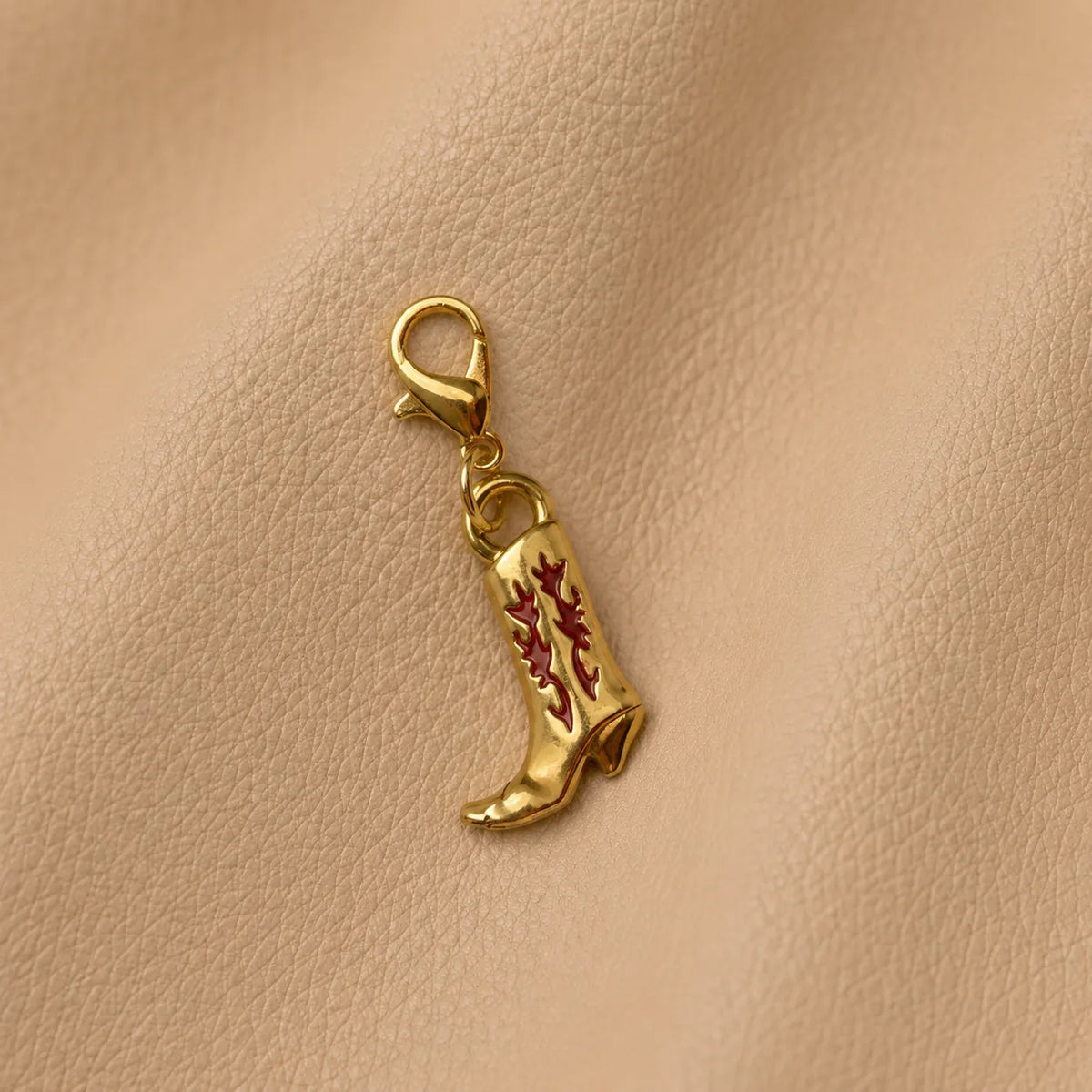 Boot-shaped journal charm attached to elastic notebook band on genuine leather journal cover