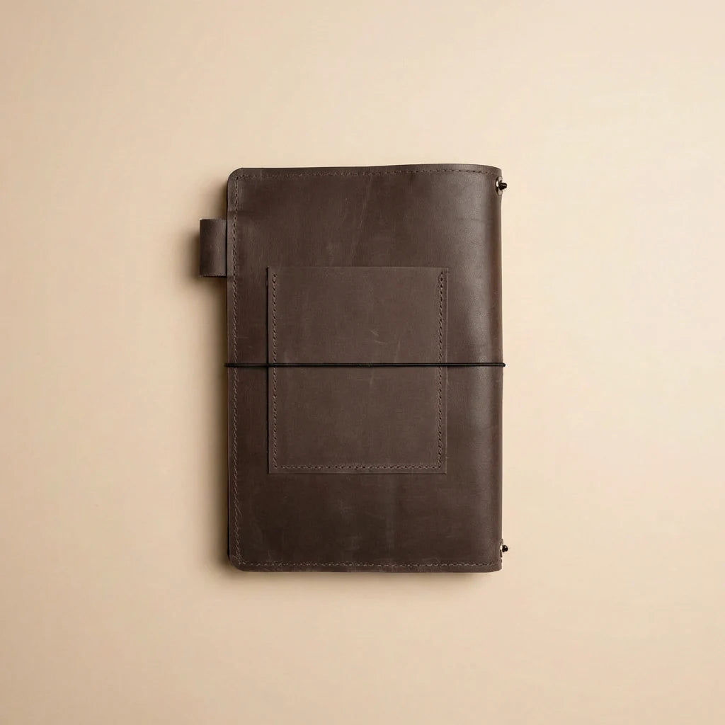 Brown leather notebook on a beige background