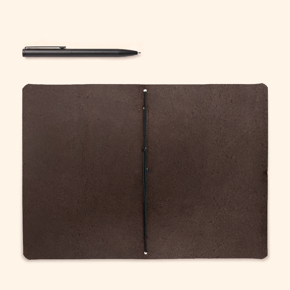 Slim leather notebook holder with one interior loop for flexible journal placement.