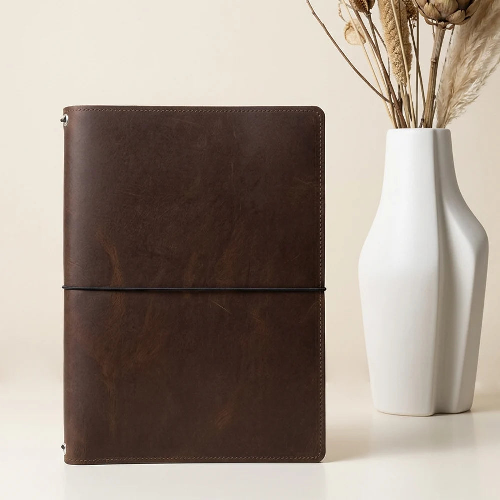 Natural leather cover crafted to hold interchangeable notebooks for everyday use.