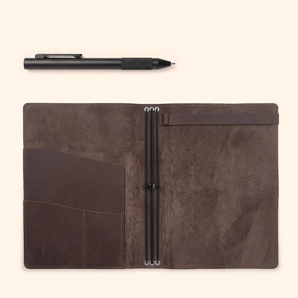 Interior view of a leather notebook cover with elastic retainers and organizer pockets.