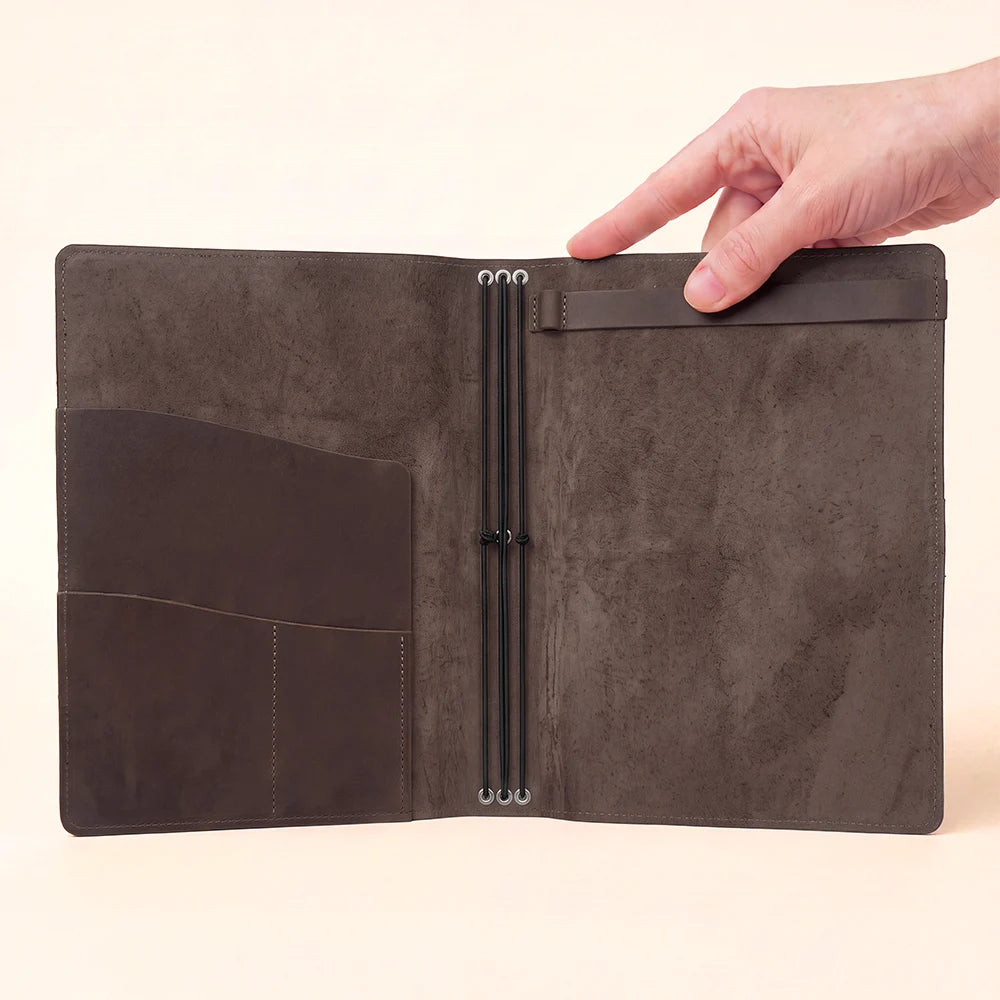 Handmade leather notebook organizer featuring interior pockets, elastic straps, and sketchbook holder.