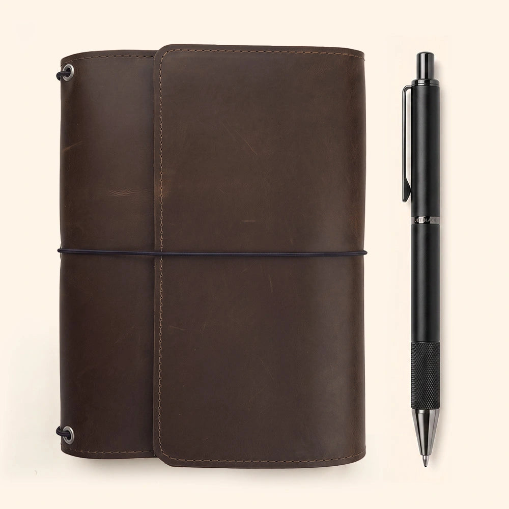Handmade journal cover with organized interior compartments and practical leather pen loop included.