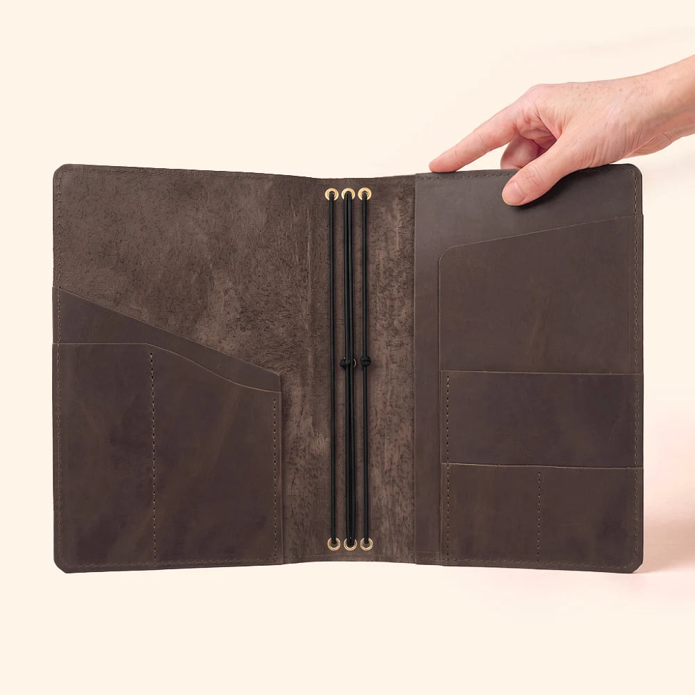 Artisan leather cover that neatly houses three interchangeable notebook booklets.