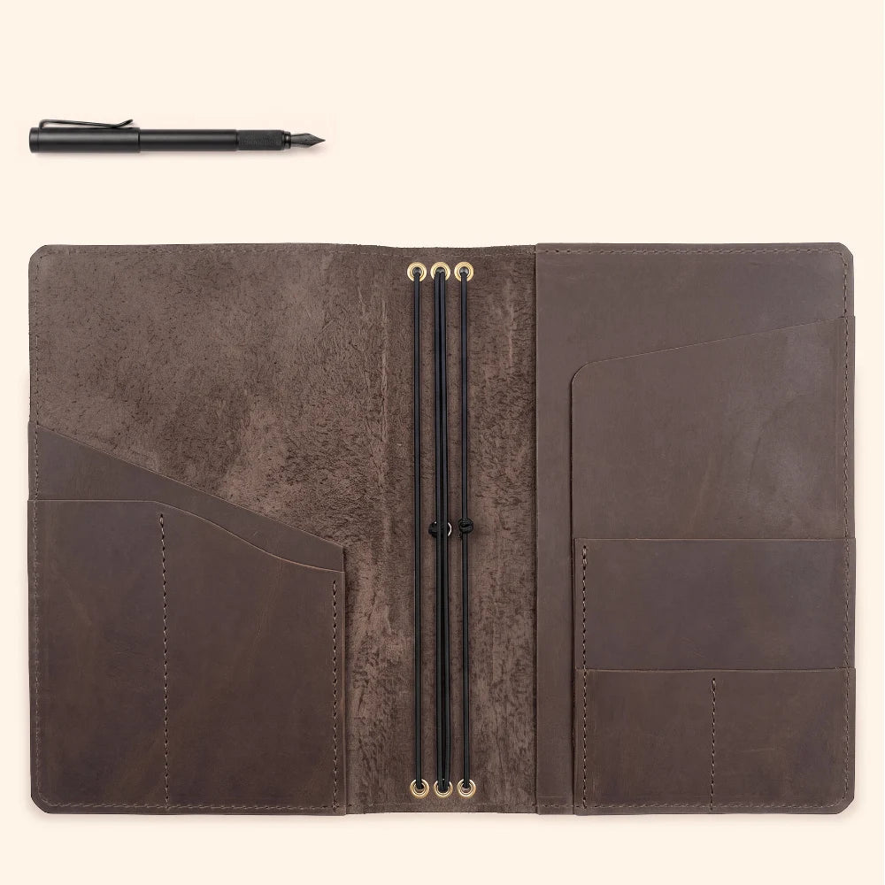 Handmade leather notebook sleeve supporting three replaceable inserts for everyday use.