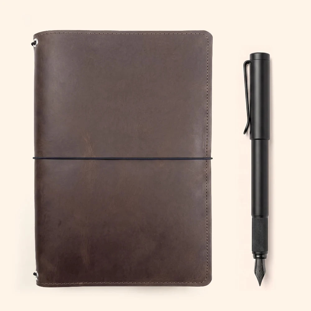 Handmade leather notebook cover with three interior loops for interchangeable refills.