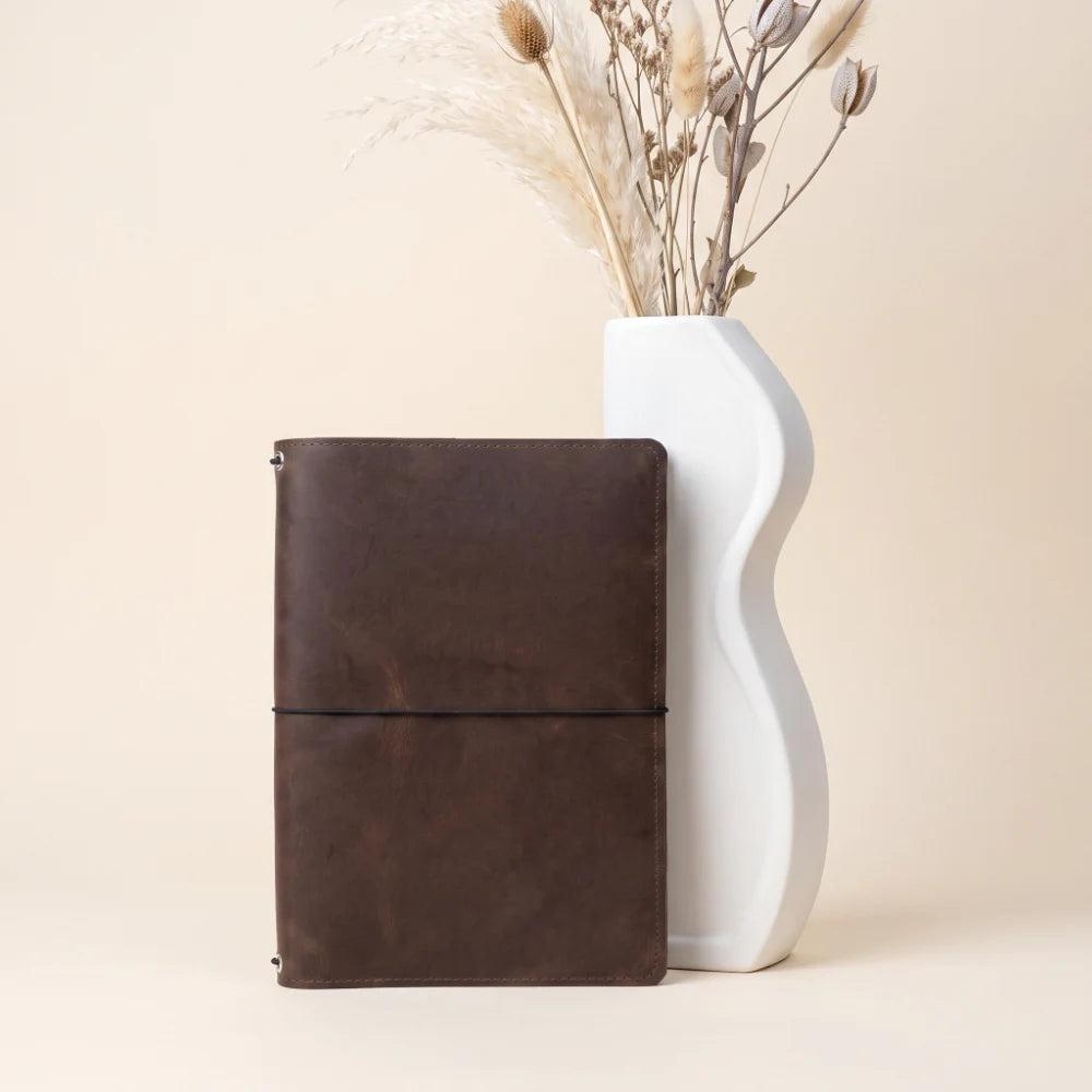 Minimalist genuine leather journal cover with three interior elastic bands.