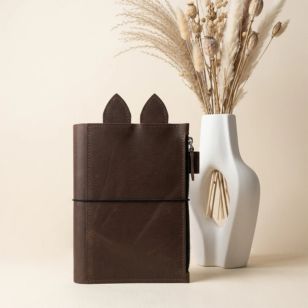Handmade genuine leather planner with large zip pocket, pen holder, leather ears, and elastics.