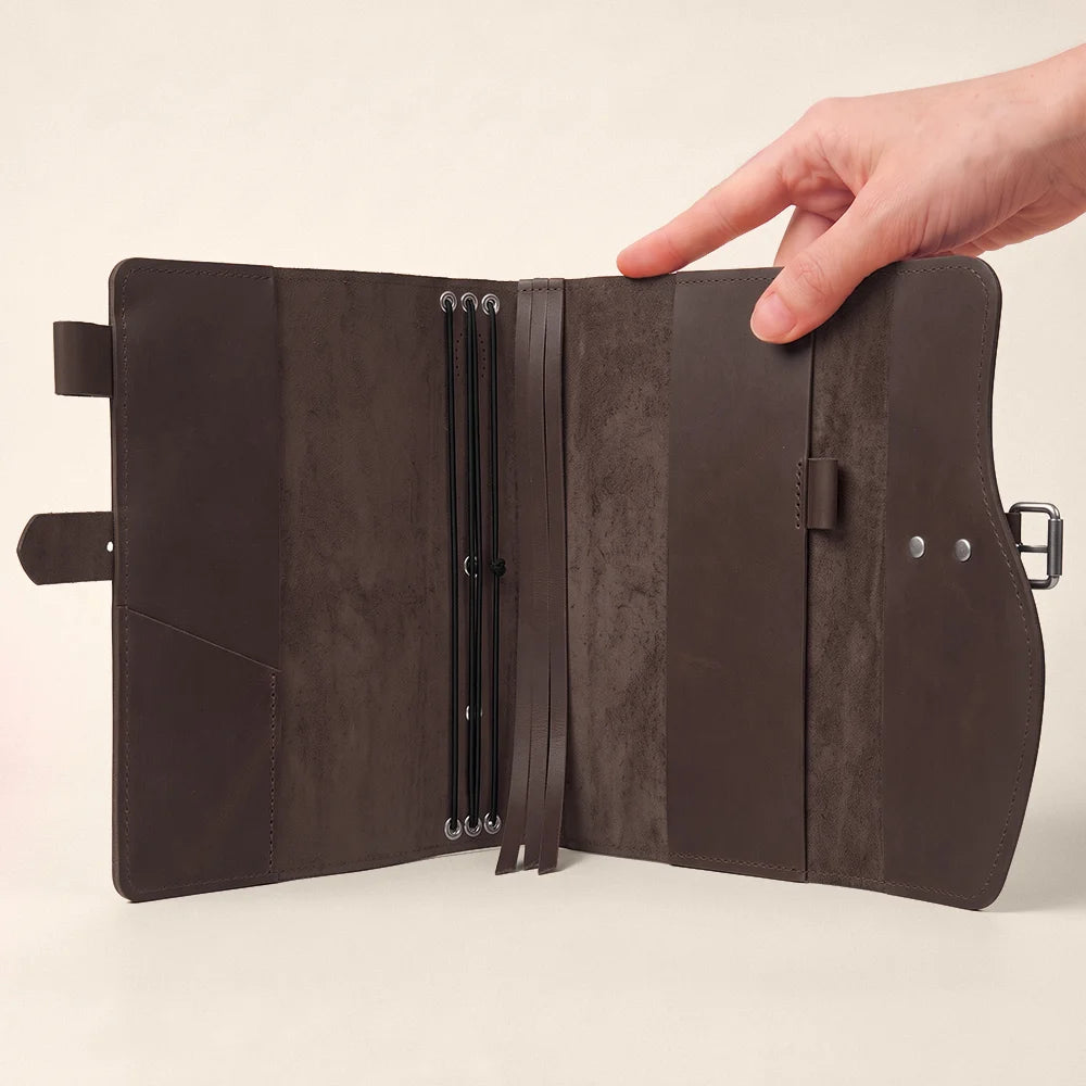 Handmade genuine leather journal cover with pockets, pen loop, bookmark, and functional external carrying handle.