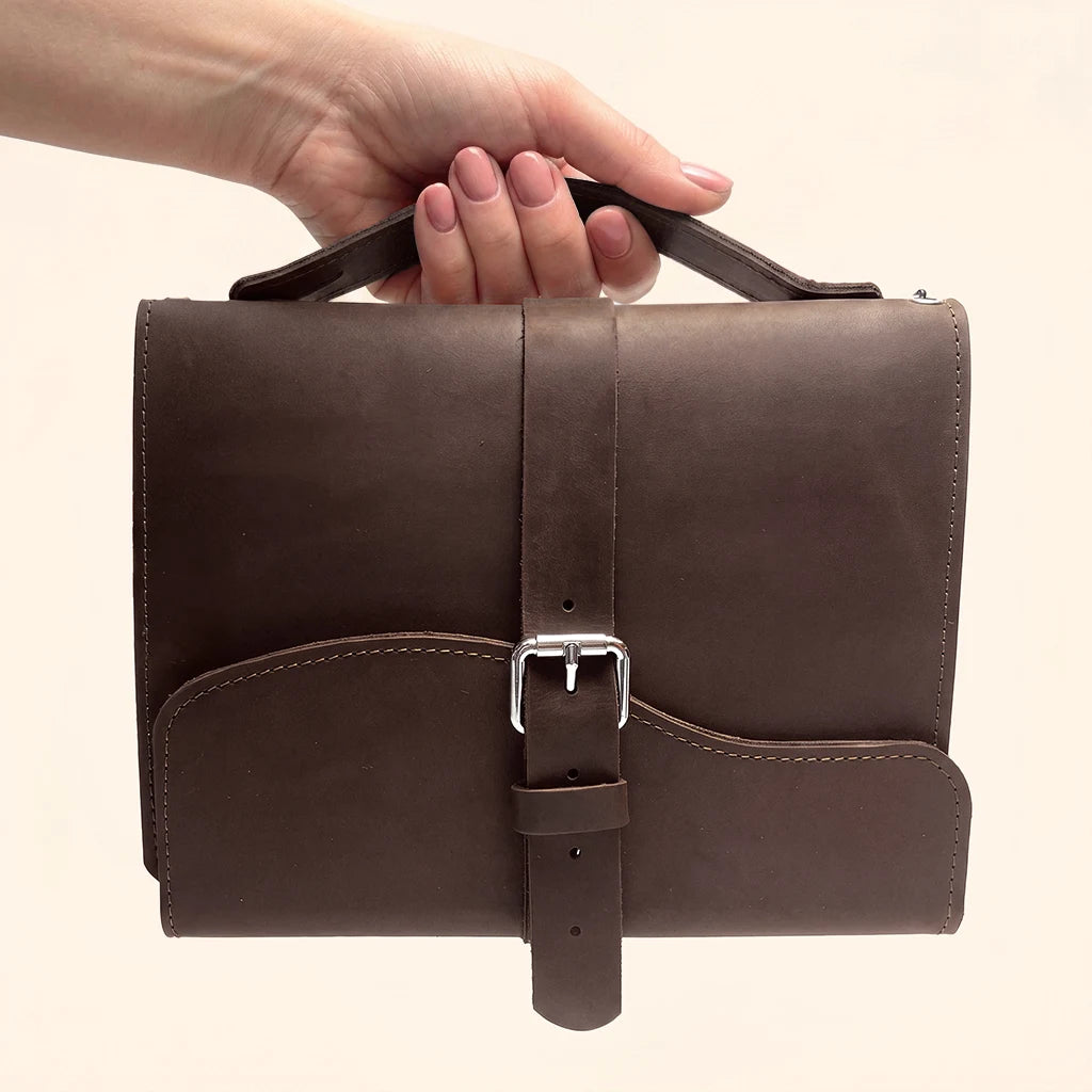 Durable genuine leather journal cover with three elastic bands and external carrying handle.