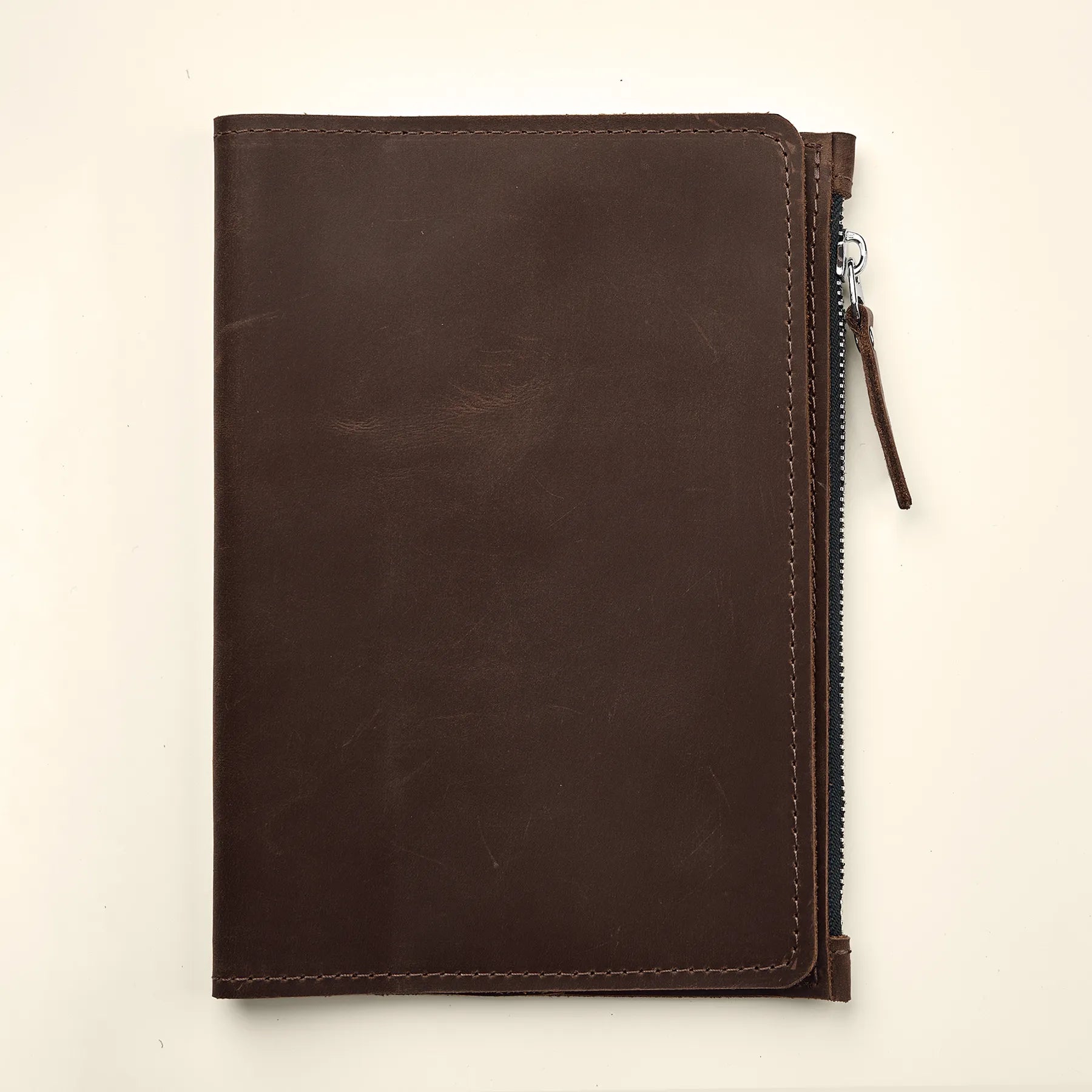 Premium leather insert for refillable notebooks with elastic band attachment system.
