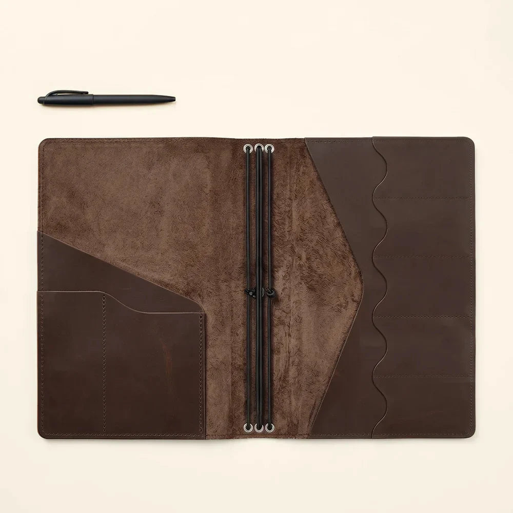 Leather notebook cover crafted with organized pockets and refillable elastic notebook system.