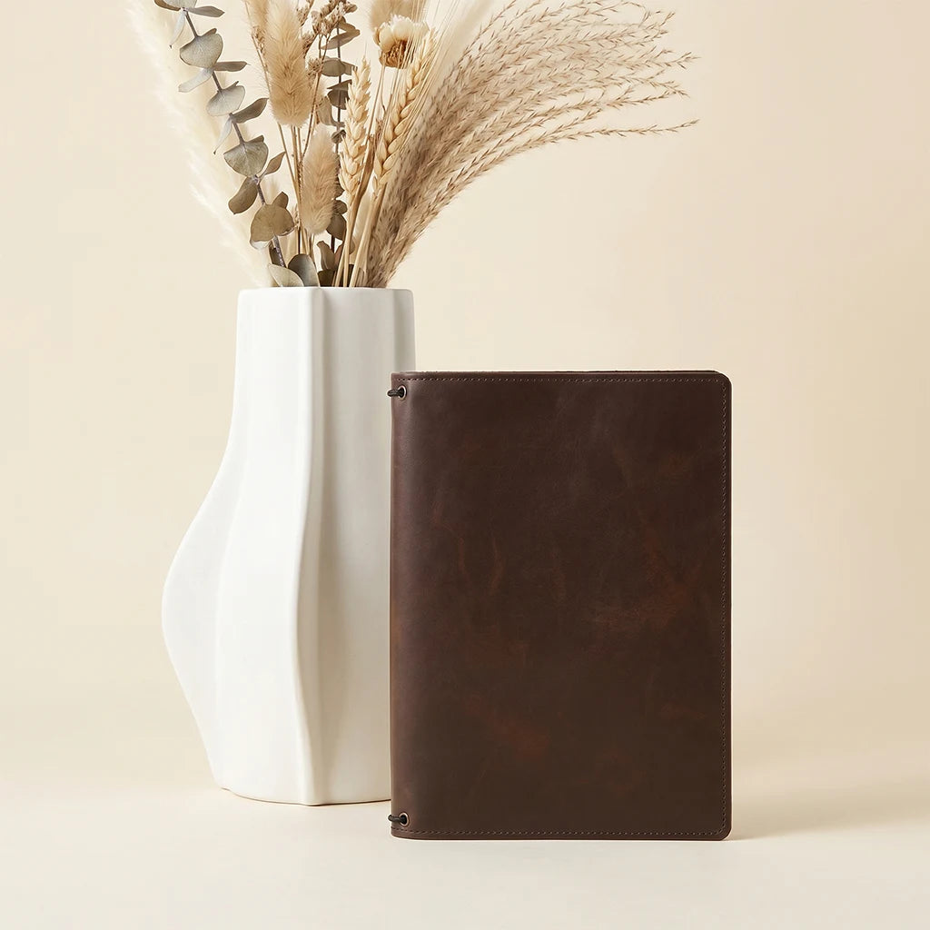 Leather journal case with expandable storage and flexible elastic configuration.