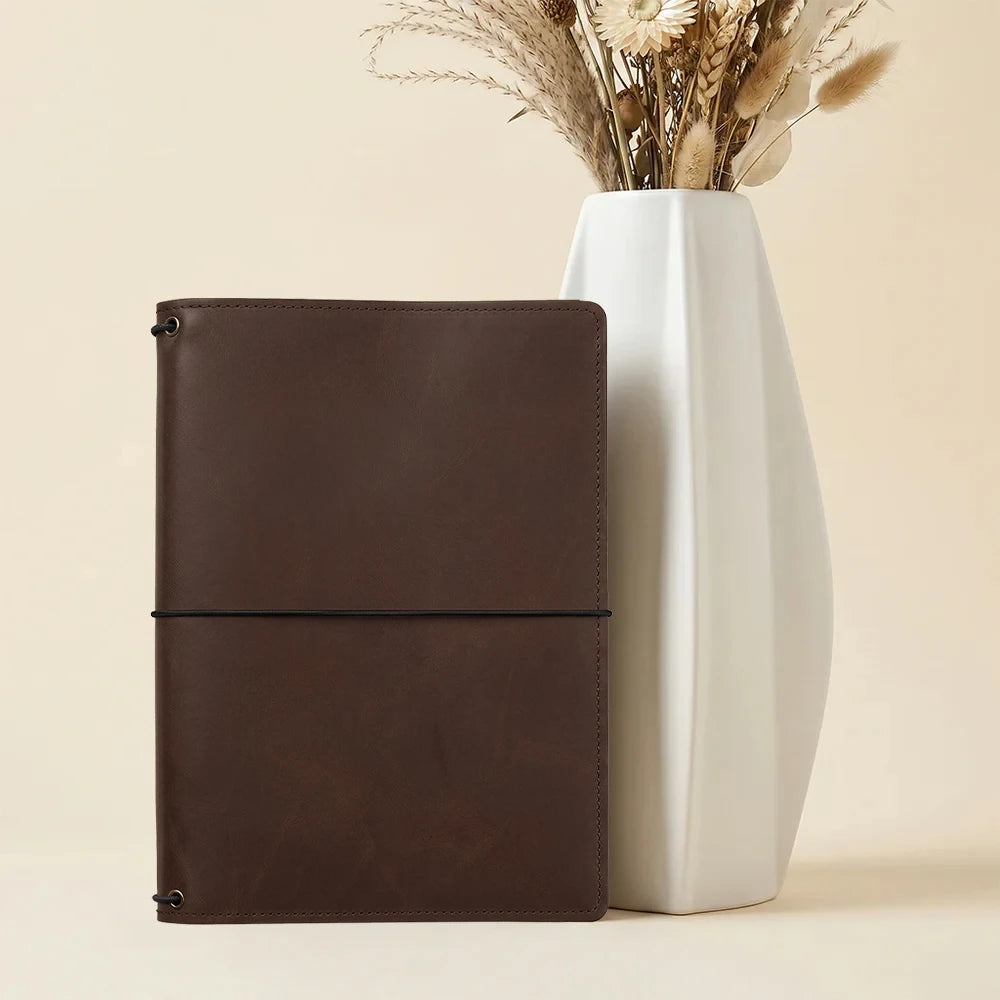 Leather notebook cover with practical card pockets and refillable three elastic band design.