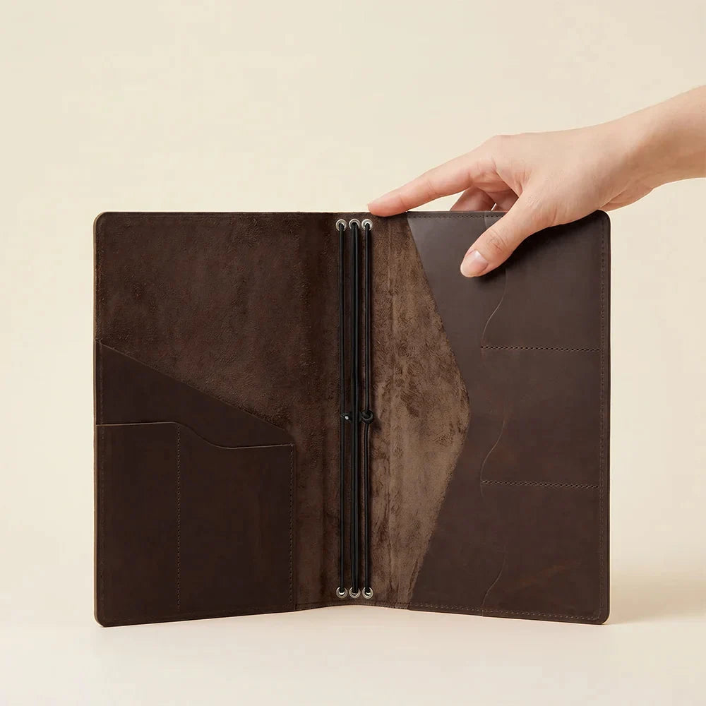 Genuine leather writing journal organizer with secure elastic notebook retention system.