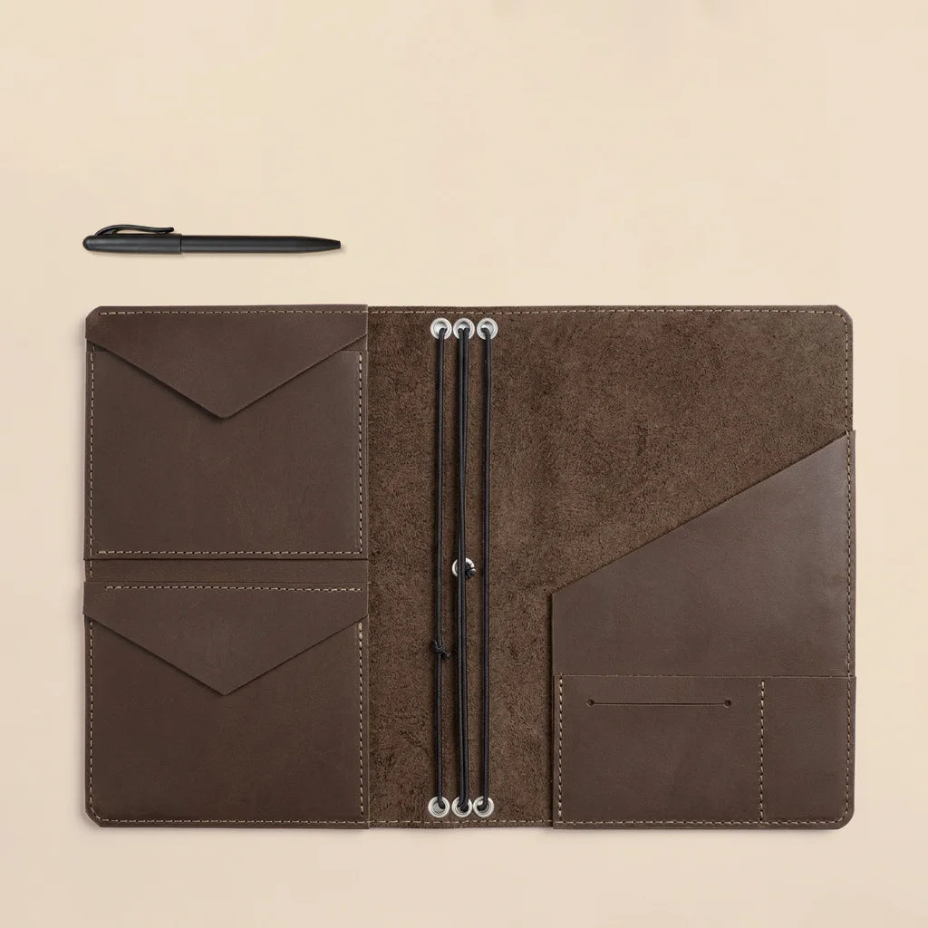 Leather journal organizer offering refillable notebook storage with premium interior pocket arrangement.