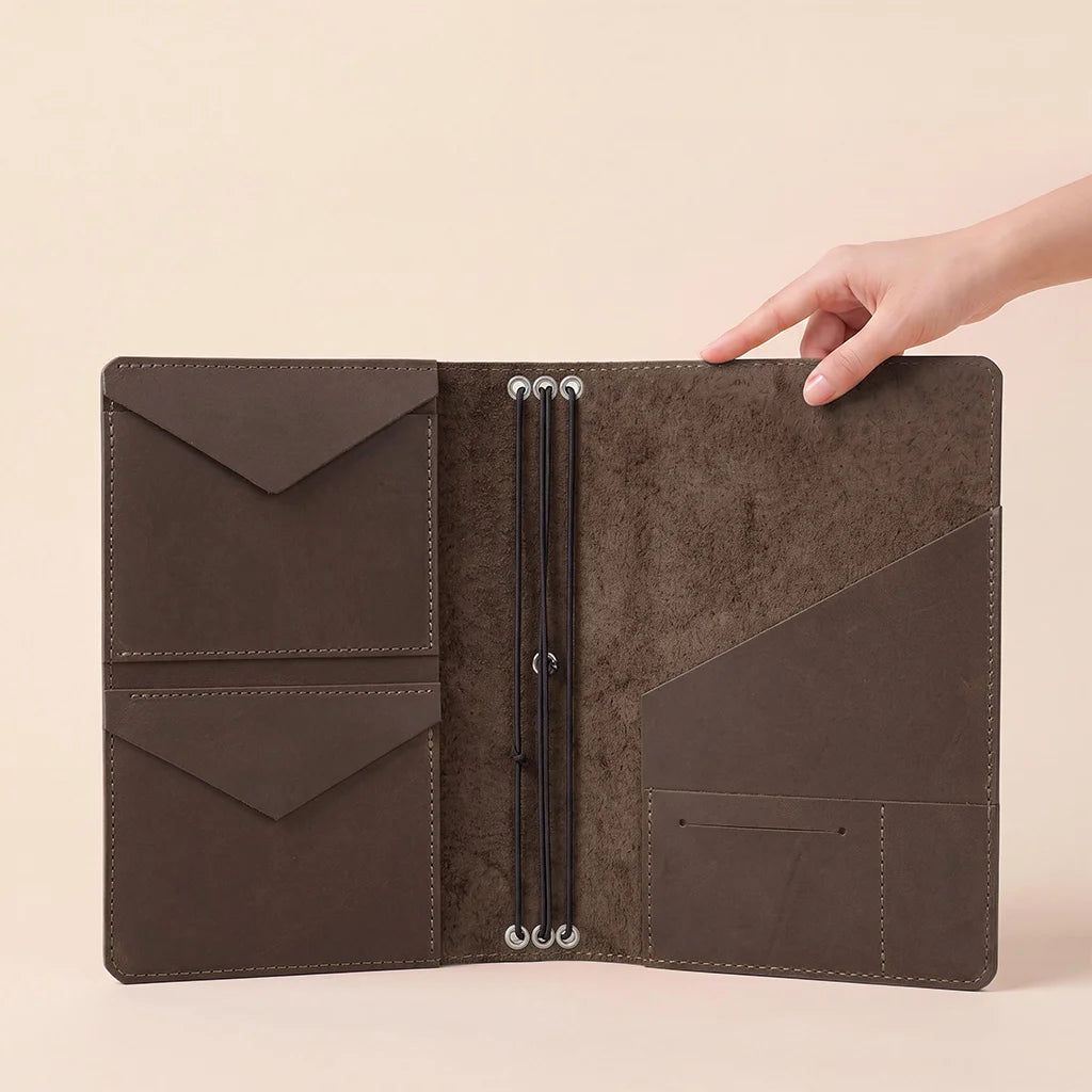 Genuine leather refillable notebook organizer featuring multiple storage sleeves inside.
