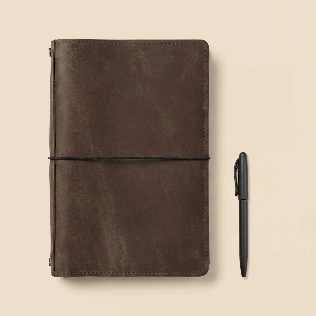 Leather planner cover crafted with durable elastic notebook holders and interior compartments.