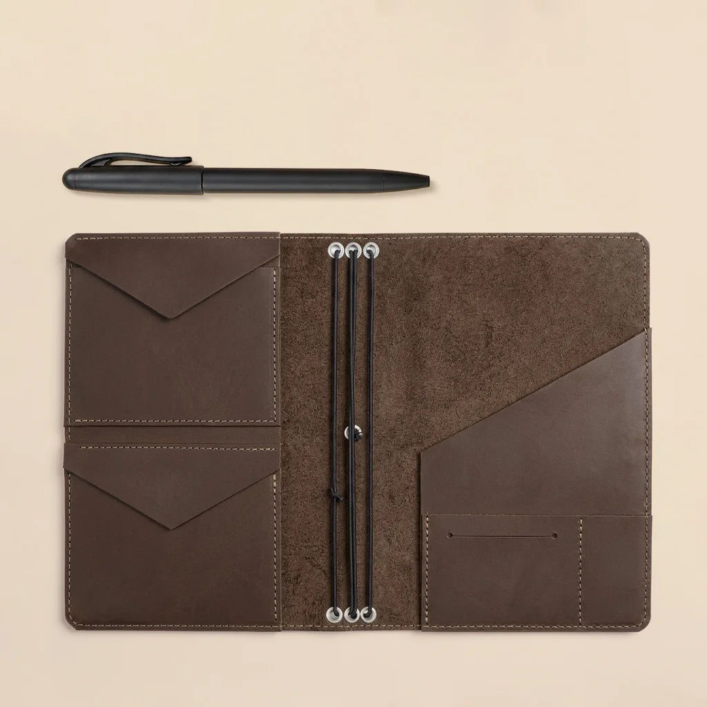 Stylish leather planner cover with multiple elastic notebook holders and practical storage pockets.