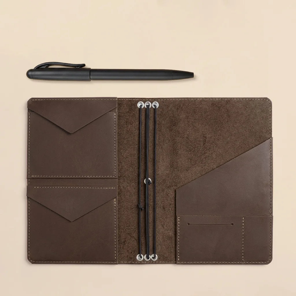 Leather journal cover designed for refillable notebooks with pockets and elastic organization system.