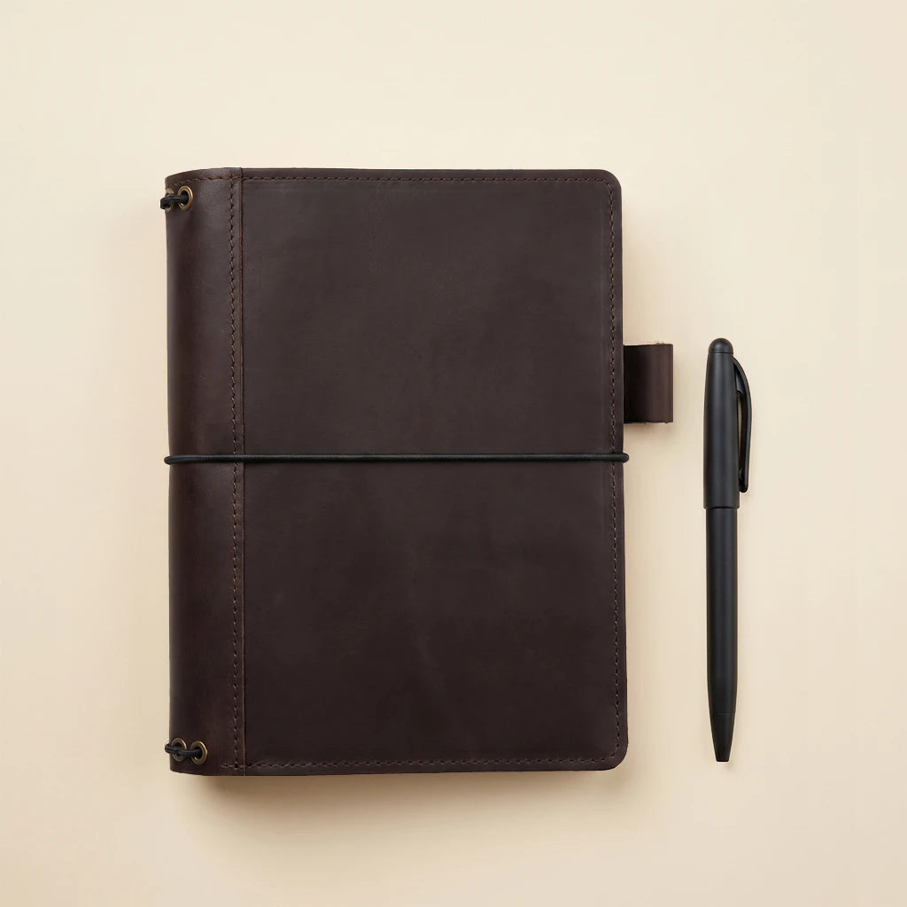 Leather notebook organizer made with five elastic cords and interior pockets