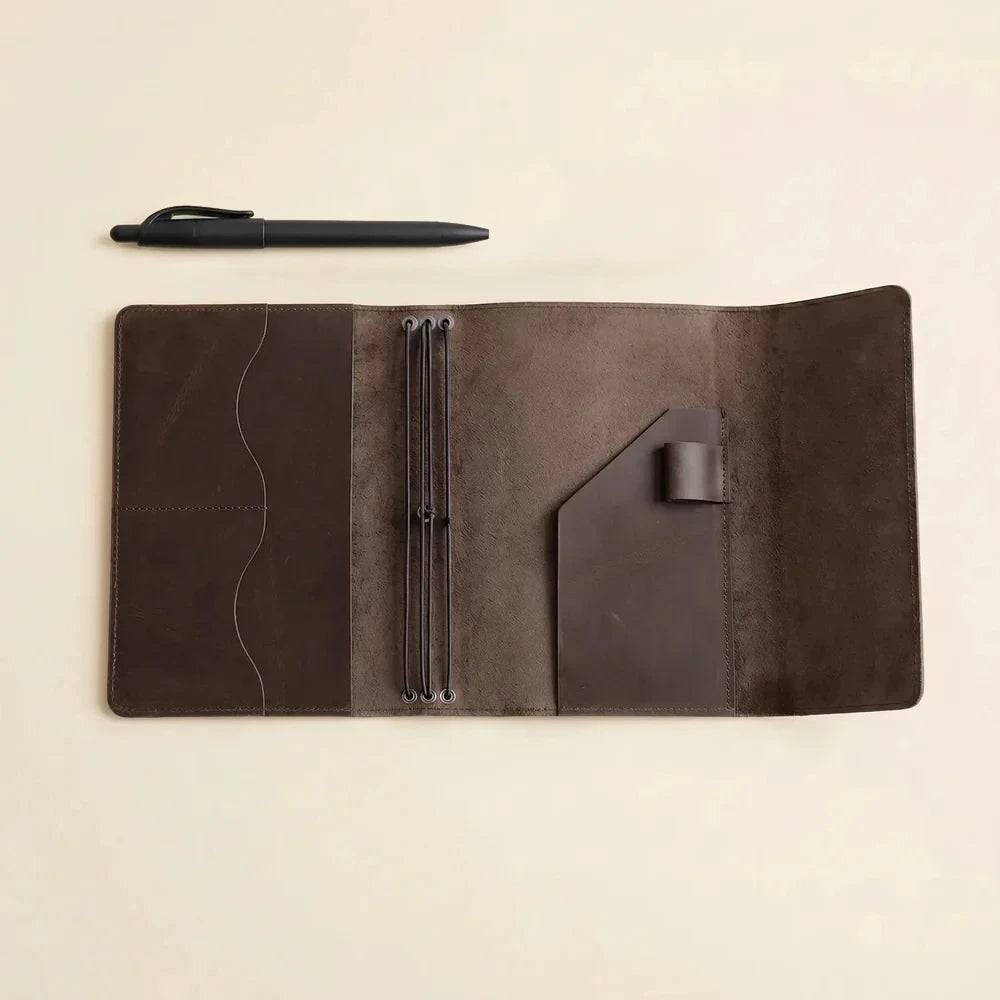 Rustic brown leather journal cover with three elastic bands and spacious inside pockets.