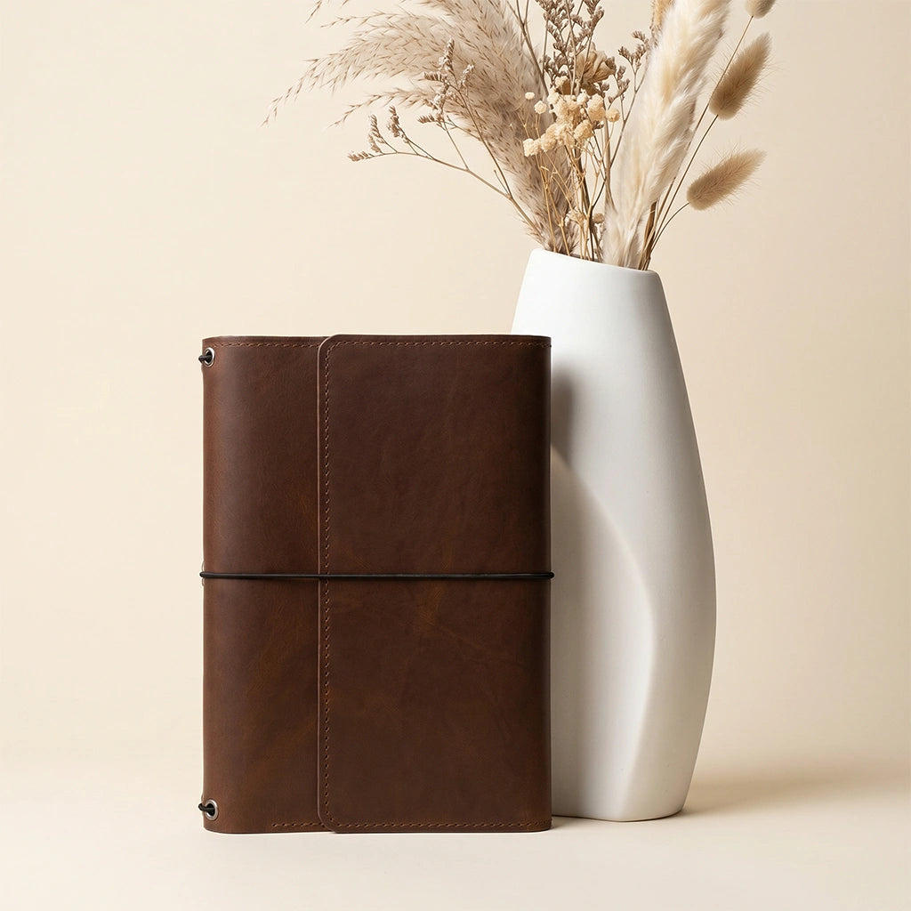 Handmade leather notebook organizer offering secure storage for journals and stationery items.