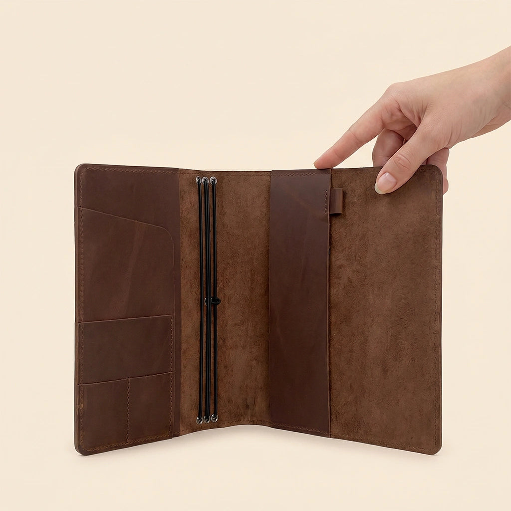 Leather refillable notebook case with interior pockets for cards, notes, and accessories.