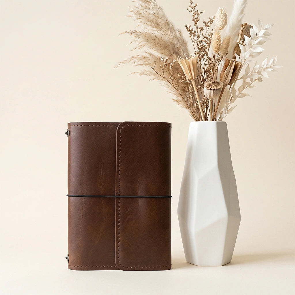 Handmade leather cover for notebook with practical pockets and elastic closure system.