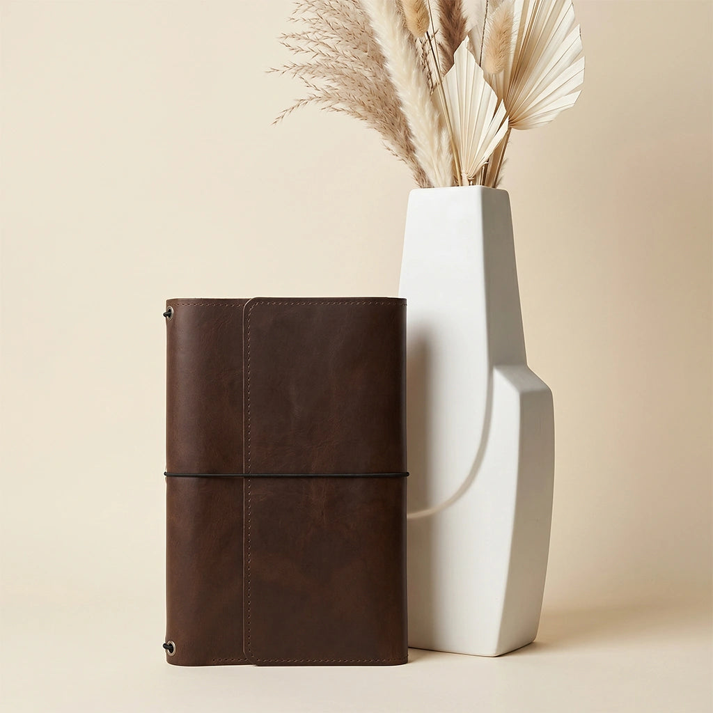 Genuine leather notebook wrap offering secure storage for journals and writing tools.