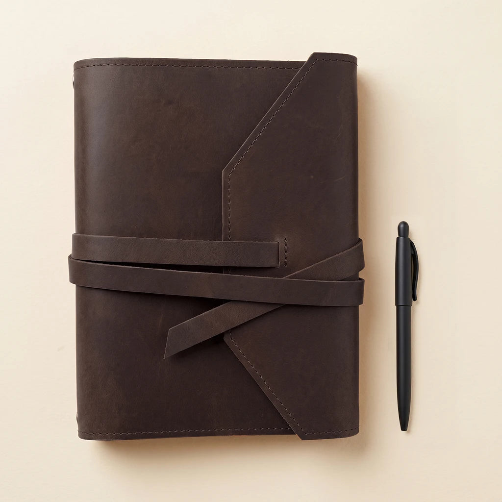 Leather journal wrap designed to organize notebooks and writing essentials.