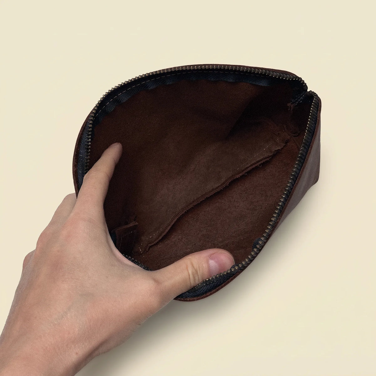 Handmade leather beauty pouch with a practical zipper closure and timeless style