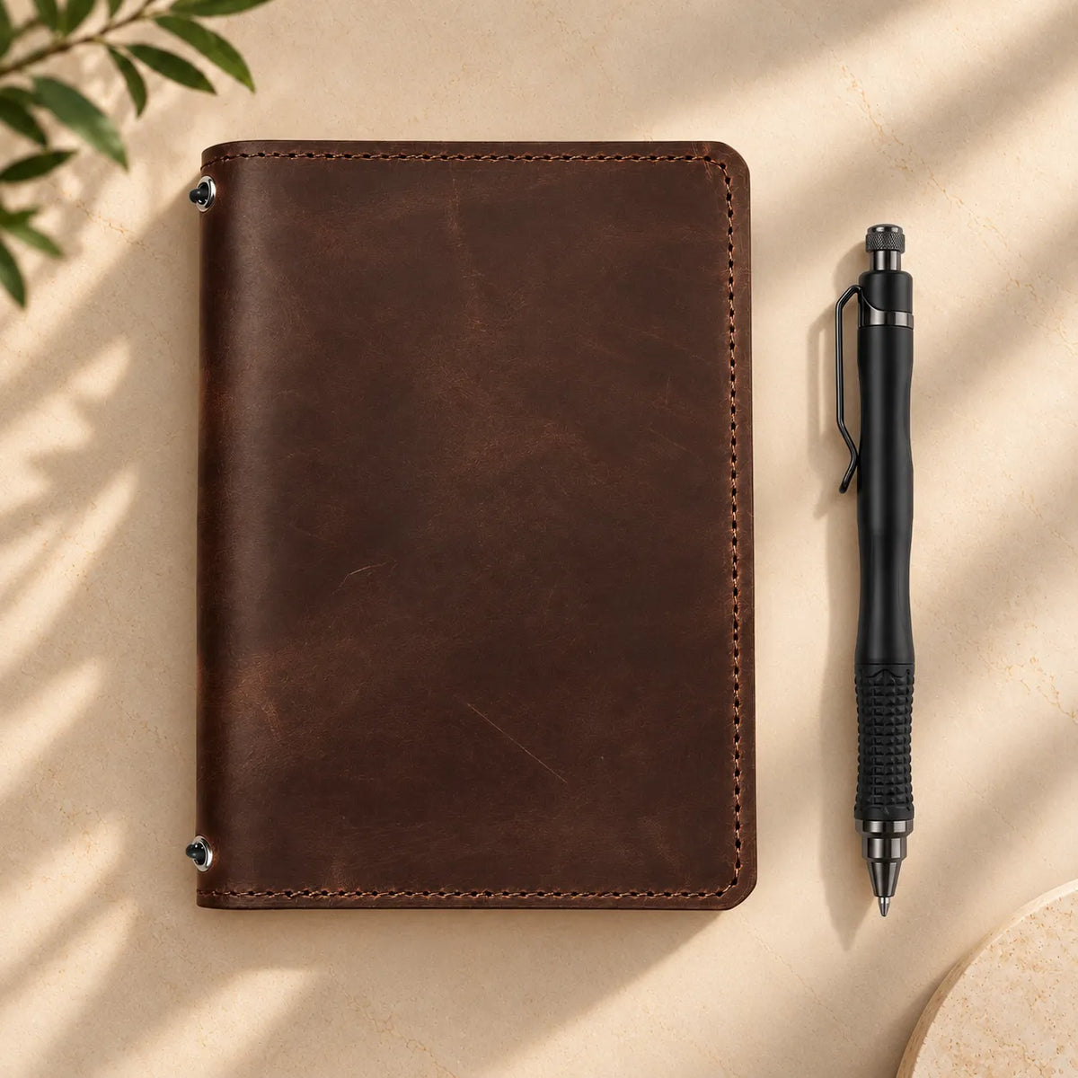 Natural leather notebook cover featuring two elastic closures and useful interior storage.