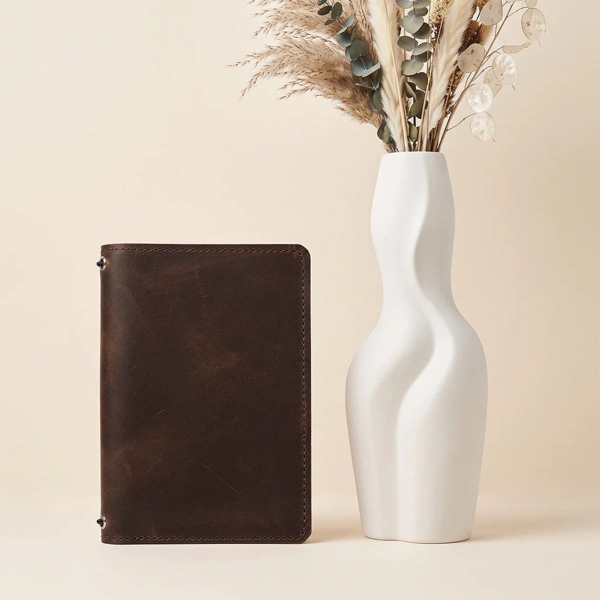 Handmade leather journal cover with practical inner pockets and two elastic bands