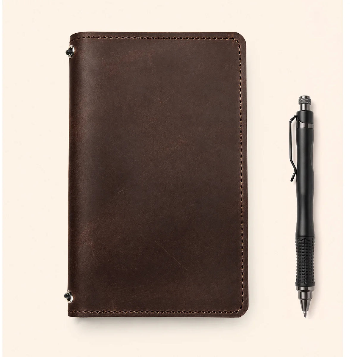 Handcrafted Crazy Horse leather notebook case displaying two elastic fasteners and interior storage
