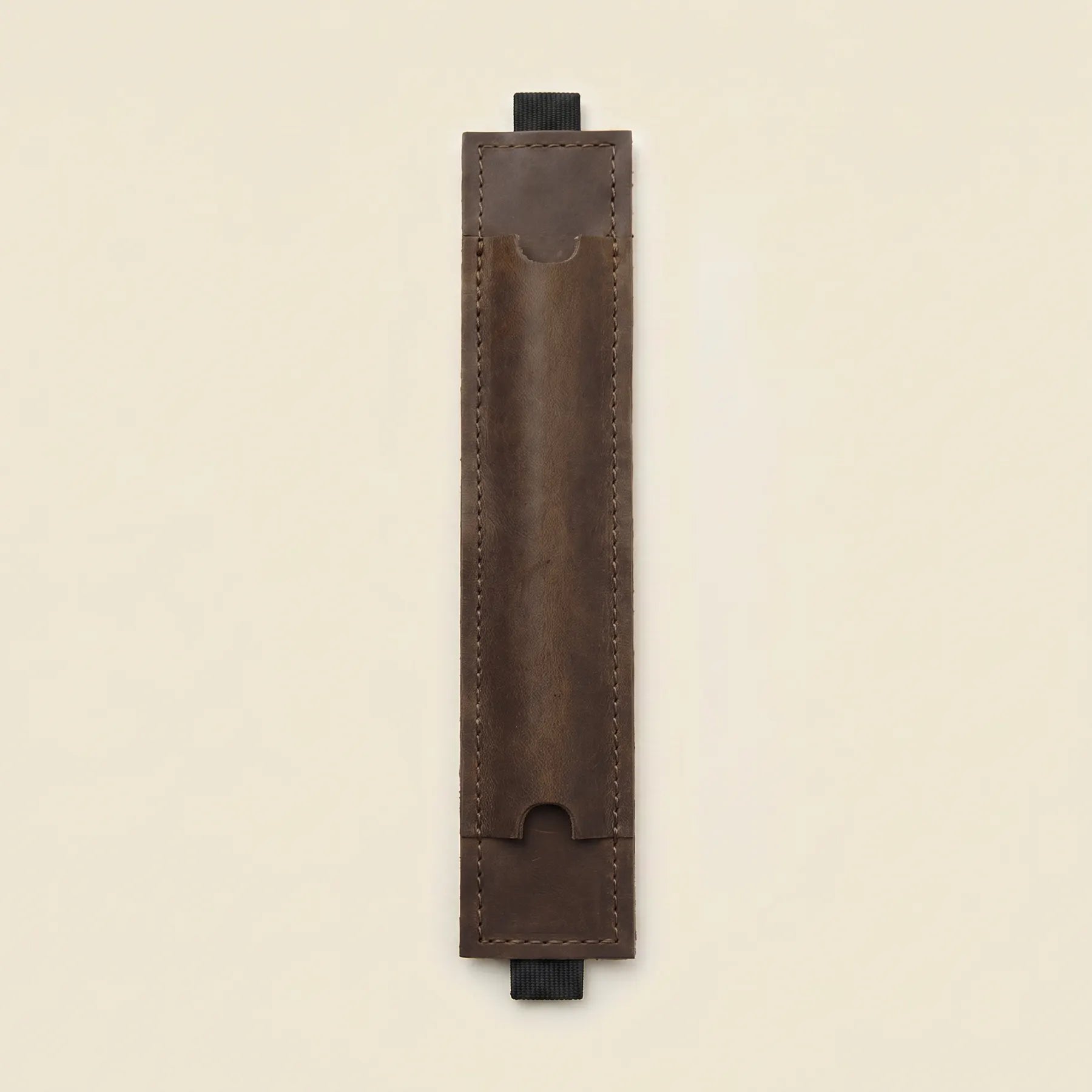 Genuine leather pen holder designed for notebooks with comfortable elastic band attachment.