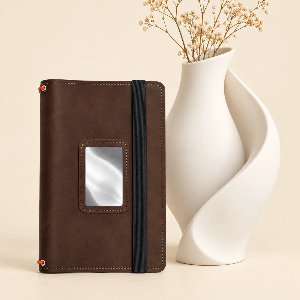 Handmade journal holder with three elastic notebook bands and useful storage pockets inside.