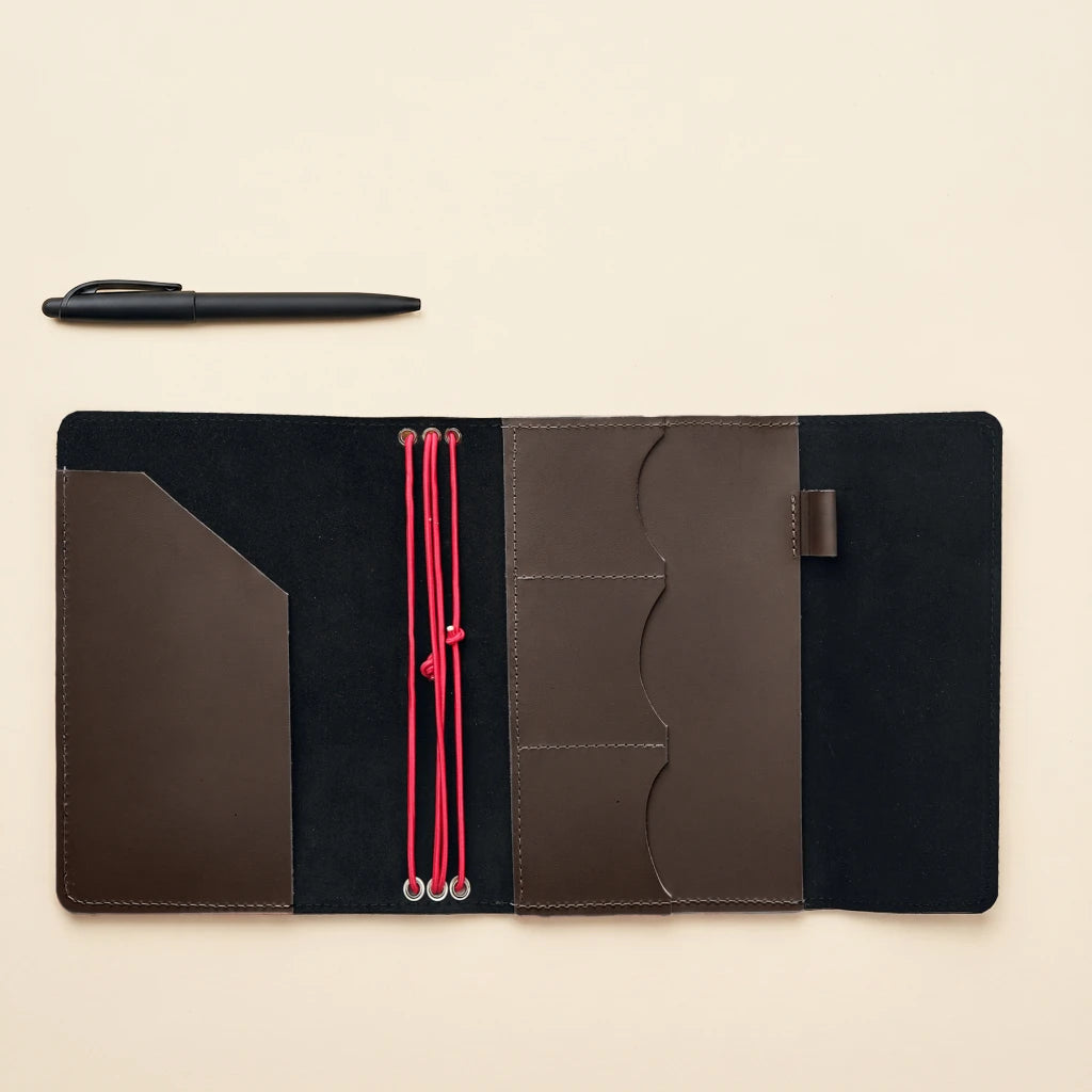 Durable leather notebook organizer with elastic closure and integrated pen holder