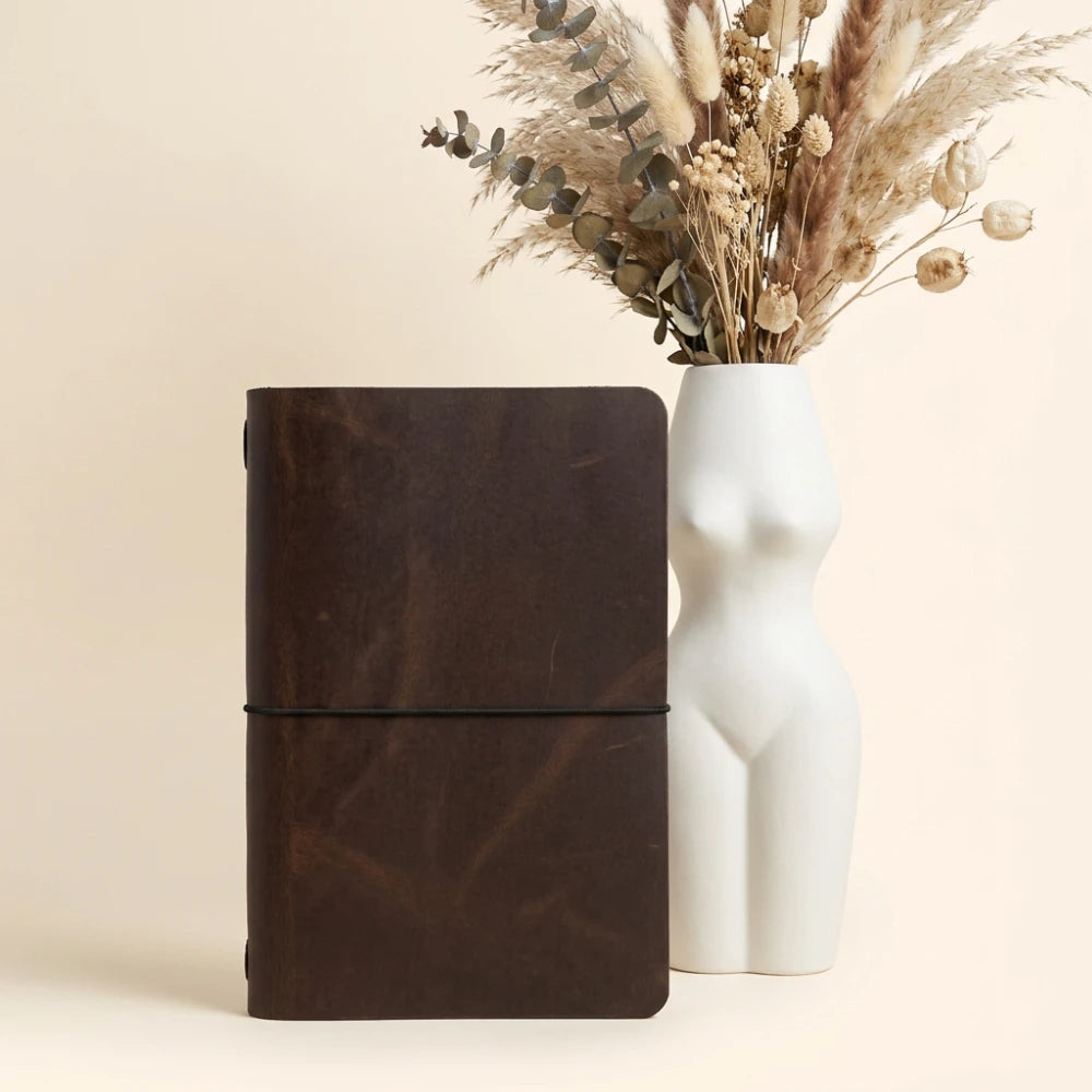 Genuine leather journal holder with minimalist design and flexible elastic notebook support.