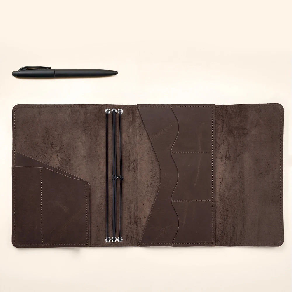 Leather notebook organizer with elegant craftsmanship and secure elastic bands for multiple journals.