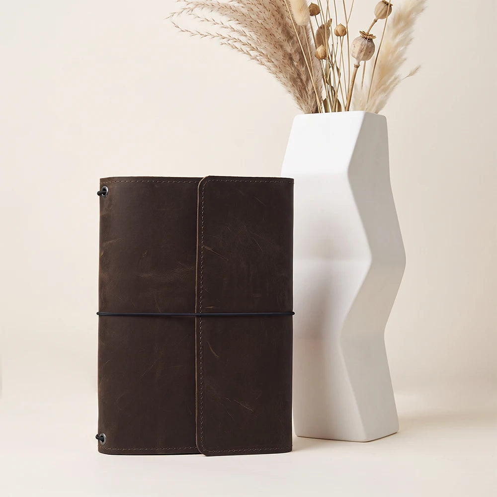 Genuine leather planner cover with handcrafted finish and interior compartments for daily organization.